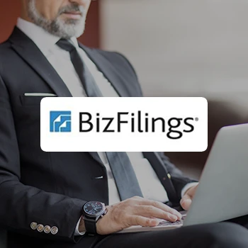 A close up shot of a business man using a laptop and a logo of BizFilings