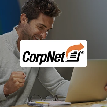 A logo of CorpNet and a happy business man using a tablet