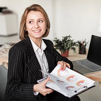 A business woman holding annual reports in her office