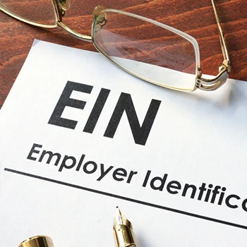 A paper showing employer identification number with eye glasses and pen on the side