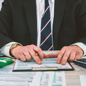 A company owner doing paperwork for business insurance premiums