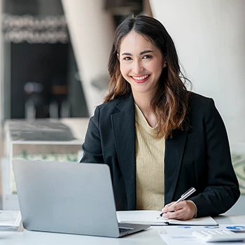 A smiling entrepreneur working on the business name reservation