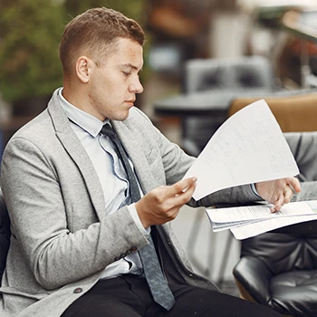 A business man sitting while arranging some paper works