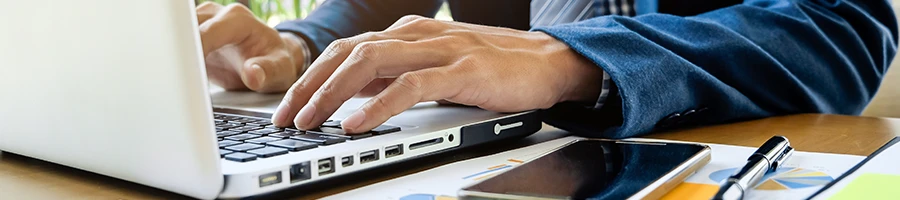 A business man working on his laptop to get sales and use tax permit