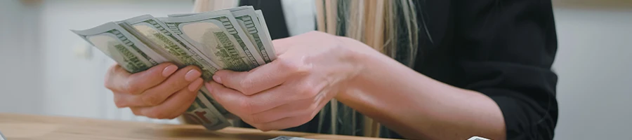 A close up shot of a woman computing the cost of an LLC in Illinois