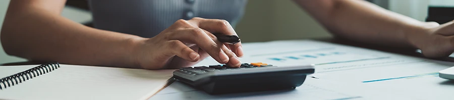 A woman computing the LLC cost in Iowa