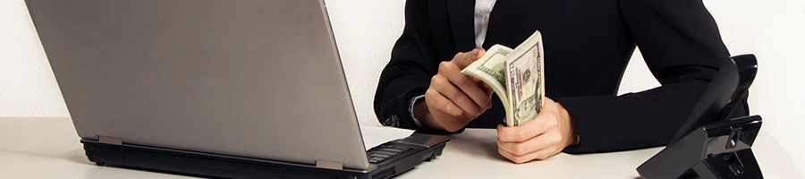 A woman working on her laptop as she look for the LLC cost in Kansas