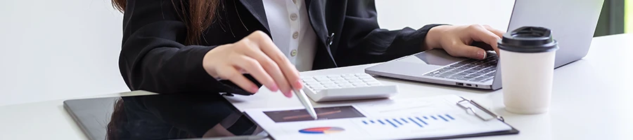 A woman reading documents while computing the LLC cost in Louisiana