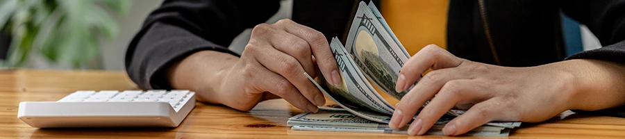 A woman computing the cost of an LLC in Indiana on her desk