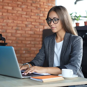 A business woman working on her laptop for LLC name reservation