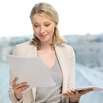 A business woman reading annual report in her office