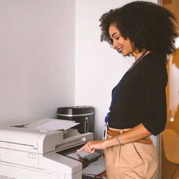 A person filing paperwork through a fax