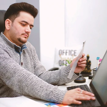 A person doing paperwork to form an LLC in Hawaii