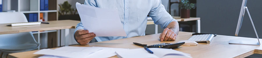 An office worker doing paperwork to start an LLC in New Mexico