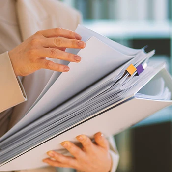 A person holding paperwork in an office