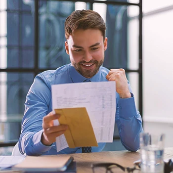 An office worker filing paper by mail