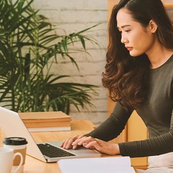 A person in an office filing paperwork online