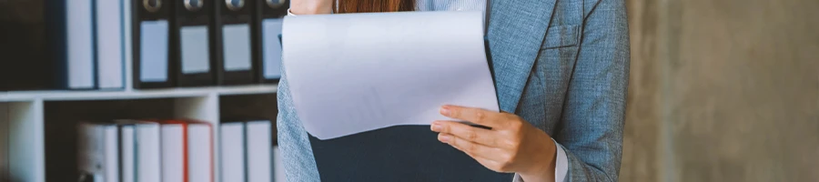 A person in an office looking at paperwork