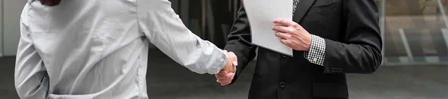 Shaking hands outdoors after changing a registered agent in New York