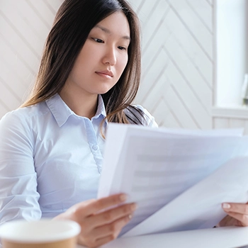 Woman reading and filing documents