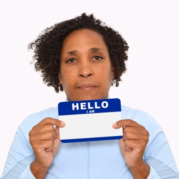 Woman holding up nametag showing name reservation for an LLC cost in Washington D.C