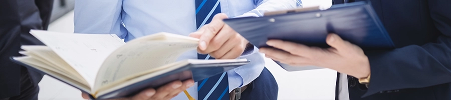 Comparing files about LLC Processing time in Pennsylvania with another person holding a clipboard