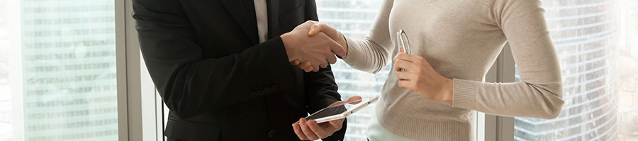 Businessman and businesswoman shaking hands