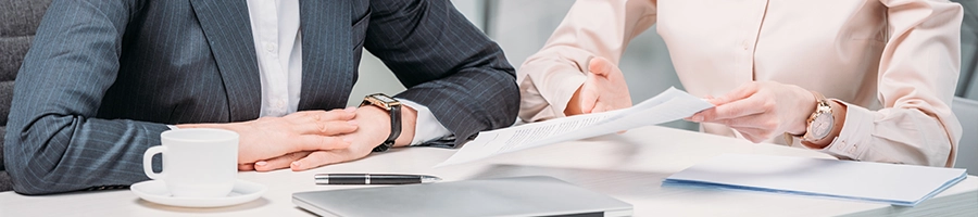 Businessmen having a meeting by the table and changing an LLC name in Nevada