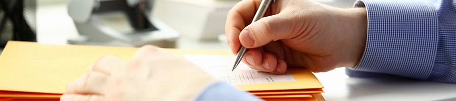 Writing on a pile of document folders in Pennsylvania office