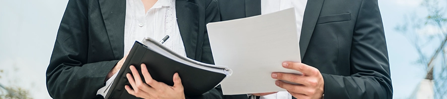 Businessmen holding important documents about changing an LLC name in North Carolina