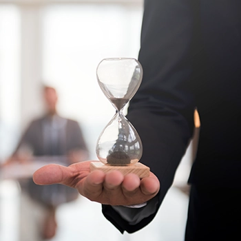 A sand timer on palm showing the time