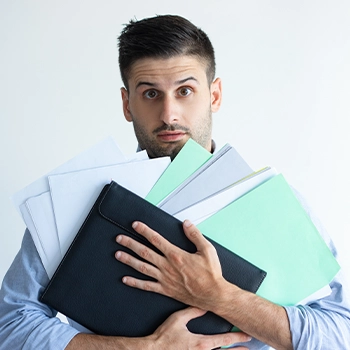 Man holding different file folders about changing an LLC name in Wyoming