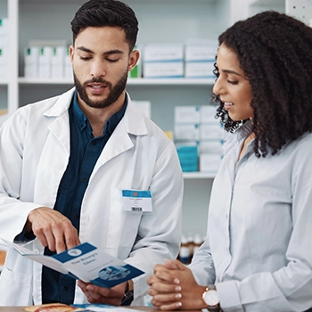 Pharmacist reading a brochure on how to start a cannabis dispensary