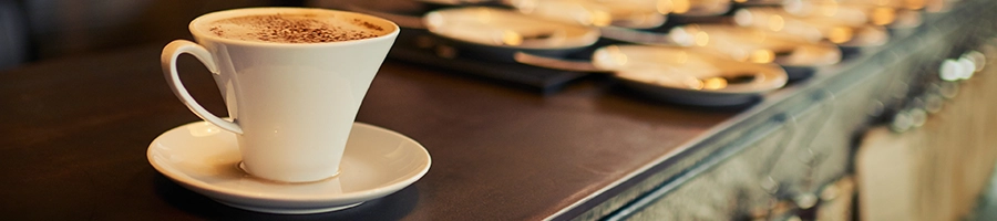 A cup of coffee on top of a coffee shop table