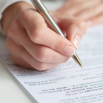 Using a pen to sign a document