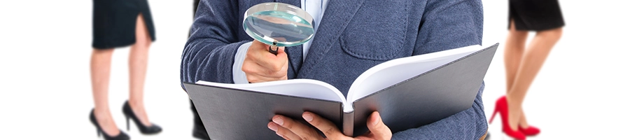 Using a magnifying glass to find business model on a book