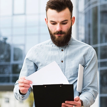 Man holding certificates and documents for licensees