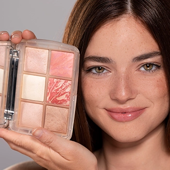 Woman smiling with her make up brand