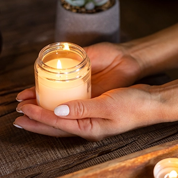 Holding a candle inside a glass