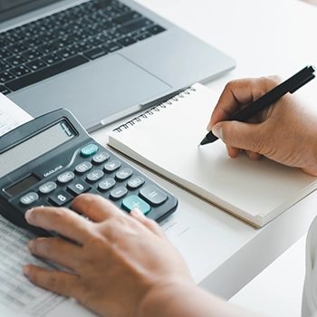 Using a calculator and a notepad in Missouri office