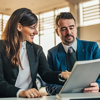 A man and a woman talking about employer taxes