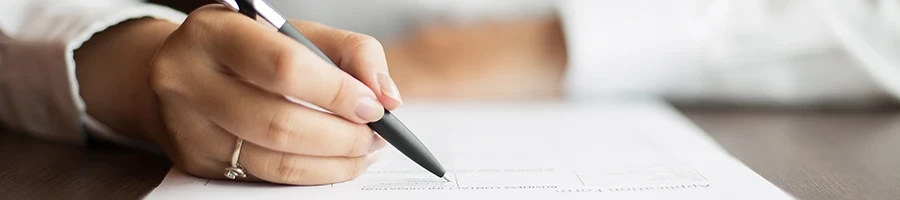 A woman reading a document on a table