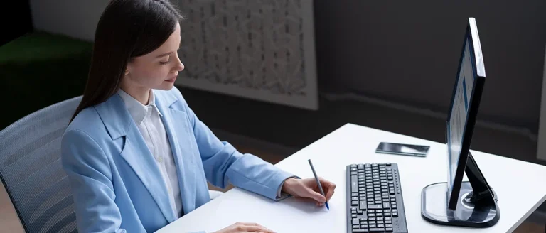 A woman working in her computer about LLC annual report in Texas