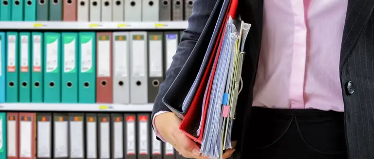 Holding a stack of document inside a folder about LLC annual report in Washington