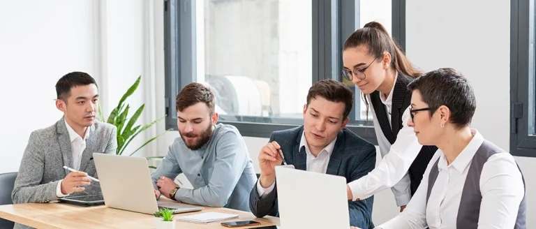 A group of business people discussing the LLC Taxes in Massachusetts