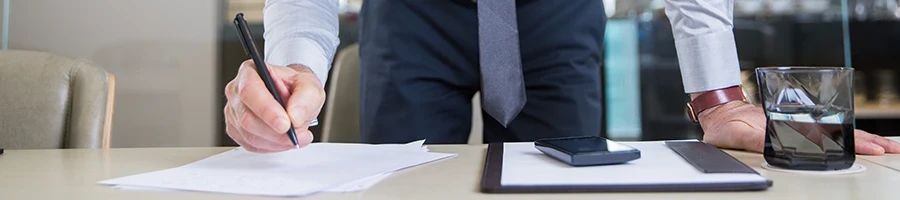 A man signing some documents