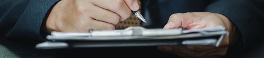 Using a pen to write documents on a clipboard