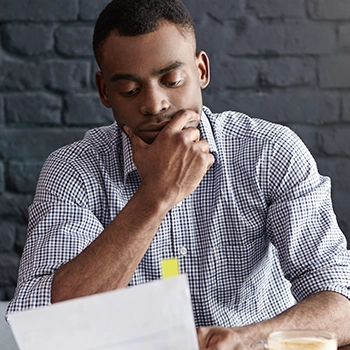 Man reading documents for sales tax