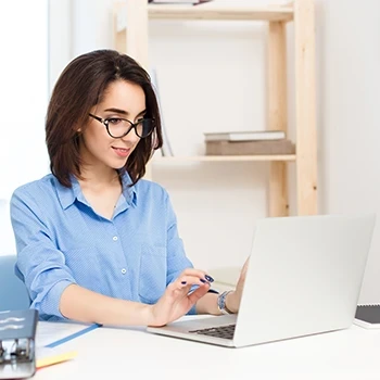 A woman working on her laptop about LLC taxes