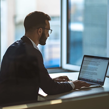 Businessman using a laptop to reach out to the state employer